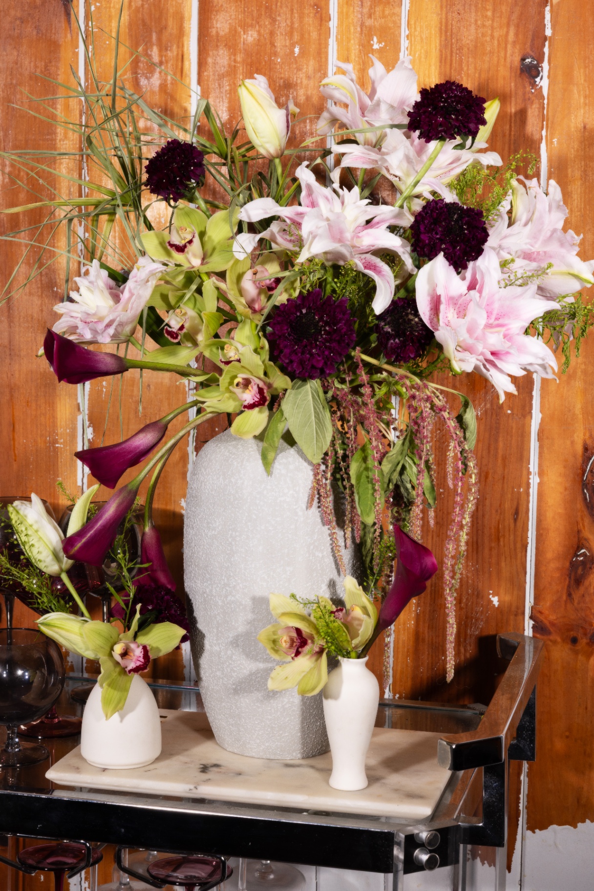 Tall sculptural arrangement with lilies, calla, scabiosa and cymbidium orchids