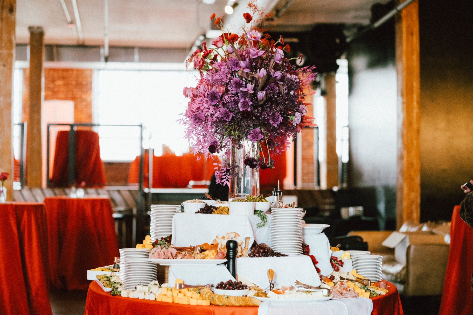 Layered grazing table with sculptural purple and crimson floral tower